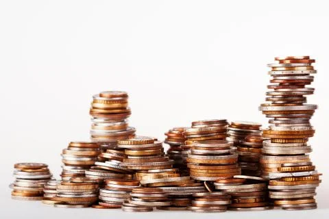 Big heap of columns of different coins on white background. May be used as sy Stock Photos