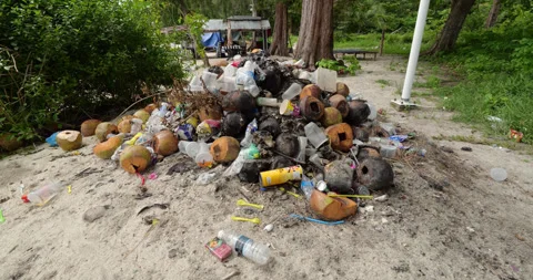 Big heap of garbage accumulating and polluting Perhentian Islands beach Stock Footage 314635978