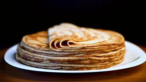 Big high stack of thin pancakes in a plate Stock Footage 93647164