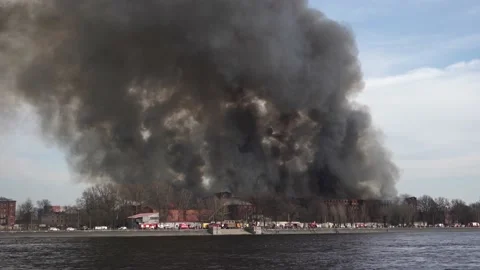 Big house is on fire. Lots of fire trucks. River embankment near. Brick house Stock Footage 152777644