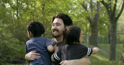 Big hug between father and sons. Slow-motion Stock Footage 131121203