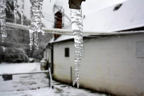 Big icicles hanging from barn Stock Photos