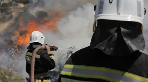 Big ignition in an open area, which boldly quenched firefighters Stock Footage 40814363