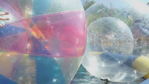 Big inflatable balls in opened pool. Sunny weather Stock Footage 71660638