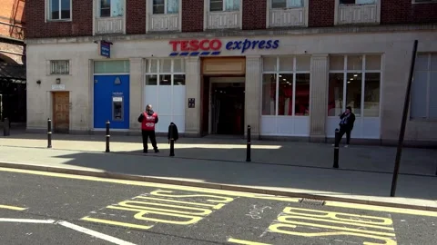 Big Issue seller outside Tesco Express on Foregate Street Stock Footage 273511561