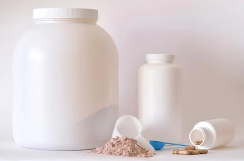 Big jar of protein powder, bottle, pills and tablets Stock Photos