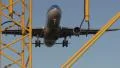 Big jet passing overhead with lampposts in front HD Footage