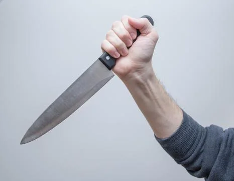 Big kitchen knife in man hand Stock Photos