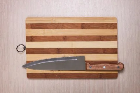 Big knife and breadboard on table Stock Photos