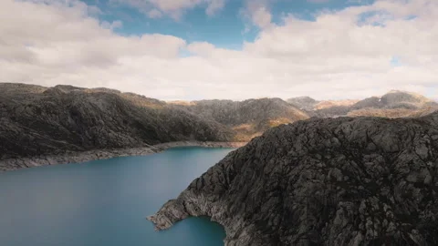 Big lake surrounded by mountains in bright day Stock Footage 255729104