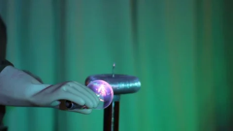 Big lamp lights up in the hands of an electric spark Stock Footage 71537474