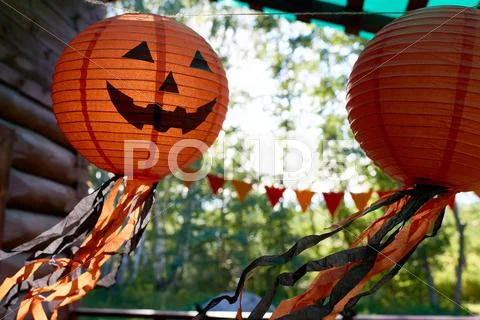 Big lanterns with scary grin hanging outdoors Stock Photos