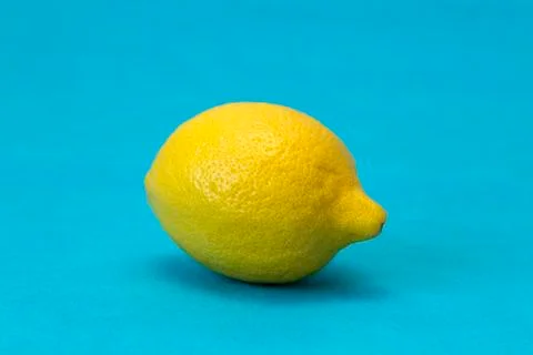 Big lemon on a blue background Stock Photos