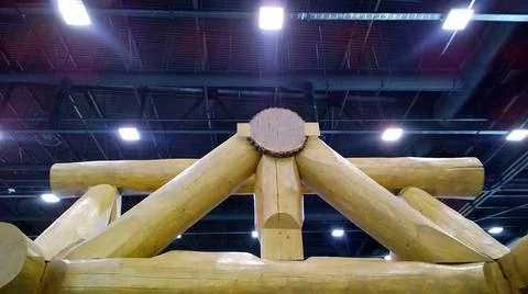 Big Log construction on dark background with light equipment. Wooden House Stock Photos