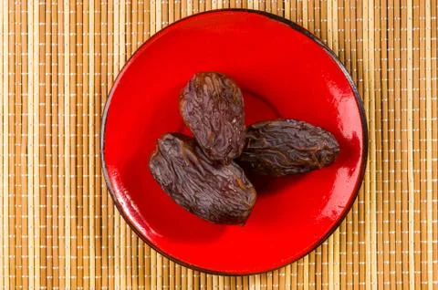 Big luxury dried date fruit in bowls on the bamboo mat, kurma ramadan kareem  Stock Photos