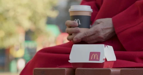 Big Mac box on a bench next to a woman. Minsk, Belarus, November 19, 2020 Stock Footage 143481954