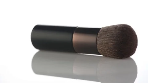 Big makeup brush rotated over white background. Professional makeup Stock Footage 101895195