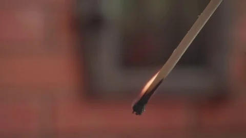 Big match burns against the backdrop of a brick fireplace Stock Footage 77057271