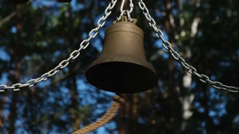Big metal bell hanging on chains outdoor. Stock Footage 217866800