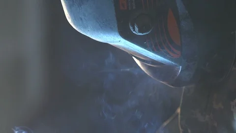 Big metallic tool looking like a futuristic hawk in fumes of smoke in workshop Stock Footage 105449296