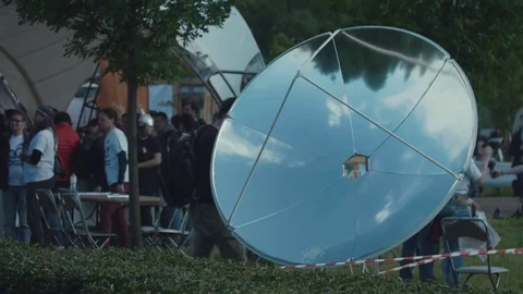 Big mirror bowl sun reflection concentrating device at city park science fair Video stock 78884055