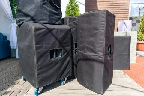Big mobile speakers in soft cases brought for installation at a street festive Stock Photos