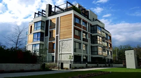 Big modern multi-storey house with windows and trees around Stock Footage 65995211