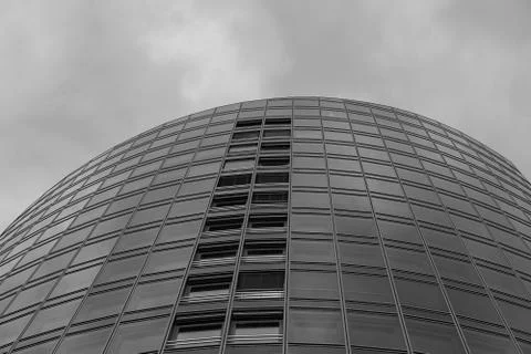 A big modern tower below a cloudy sky Stock Photos