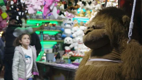 Big Monkey at Night Park and Dad Shooting At Carnival Gun Range Game Stock Footage 123371559