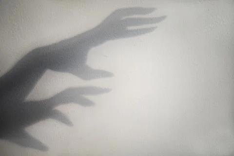 Big monster claw shadow on wall. Horror hand shadow on a white background Stock Photos