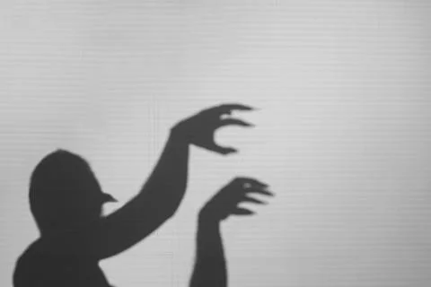 Big monster claw shadow on wall. Horror hand shadow on a white background Stock Photos
