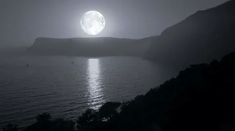 Big moon illuminates the mountains and the sea Stock Footage 24019209
