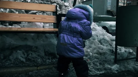 A big mountain of dirty snow behind a bench Stock Footage 148213481