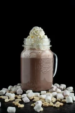 Big mug of hot cocoa with ice cream, whipped cream, chocolate chips and fluff Stock Photos