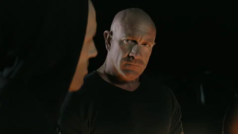 Big muscular guy looking seriously into the rest of her gang Stock Footage 262329561