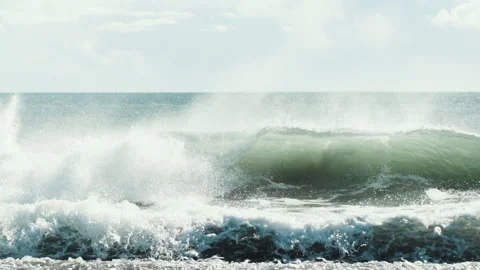 Big ocean wave breaking onto a shingle beach in Iceland slow motion Video stock 348026498