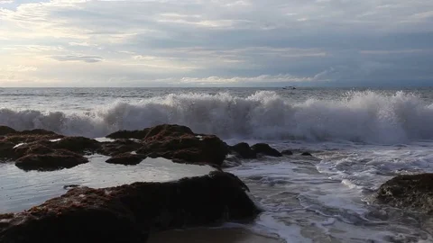 Big ocean wave crashes down on a stone Stock Footage 73611640
