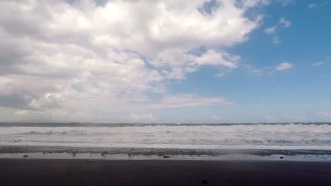 Big ocean waves breaking the shore of black volcanic beach. Slow motion view. Stock Footage 137725696