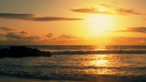 Big ocean waves hitting across huge stones with birds flying over sunset view. Видео 106850957