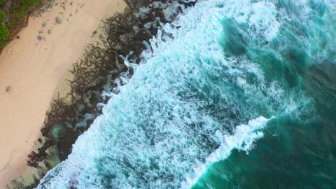 Big ocean waves hitting a rocky beach. Aerial 4k footage. Stock Footage 130871954