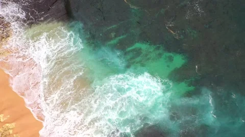 Big ocean waves hitting a rocky beach. Aerial 4k footage. Stock Footage 130872284