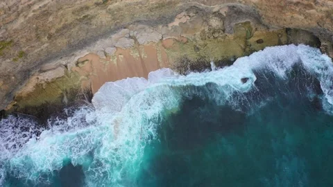 Big ocean waves hitting a rocky beach. Aerial 4k footage. Stock Footage 130872659