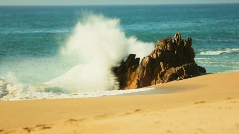 Big ocean waves rushing over jagged rocks by the beach. slomo C Stock Footage 107009220