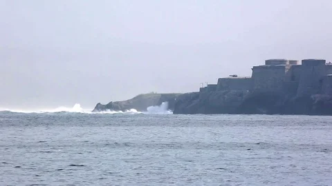 Big oceanic waves crash on rocky shore Stock Footage 76850834