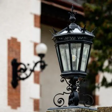 Big old black lantern in front of an old house Stock Photos