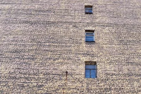 Big old brick wall with windows Stock Photos