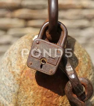 Big old rusty padlock to lock a chain Stock Photos