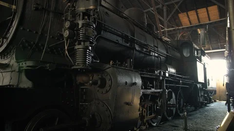 A big old steam locomotive parked in an abandoned warehouse Stock Footage 107178341