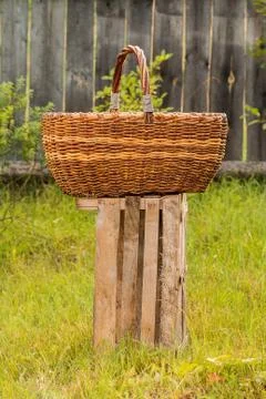 Big old weathered empty wicker laundry basket Stock Photos