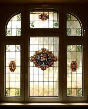 Big old window with beautiful colored murals Stock Photos